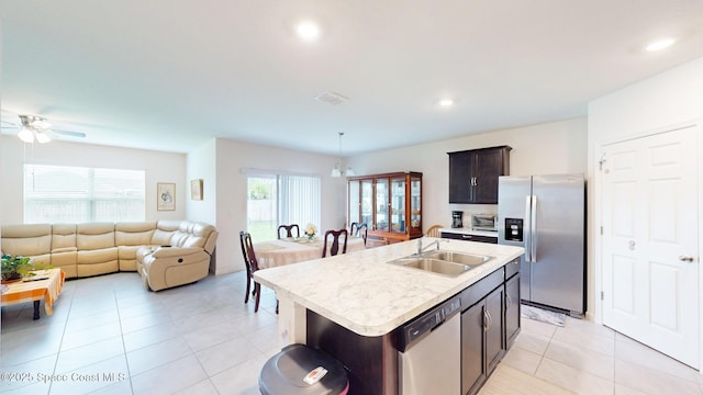 1491 Higbee St SE, Palm Bay, FL 32909 - kitchen featuring appliances with stainless steel finishes, a sink, light countertops, a ceiling fan, and open floor plan