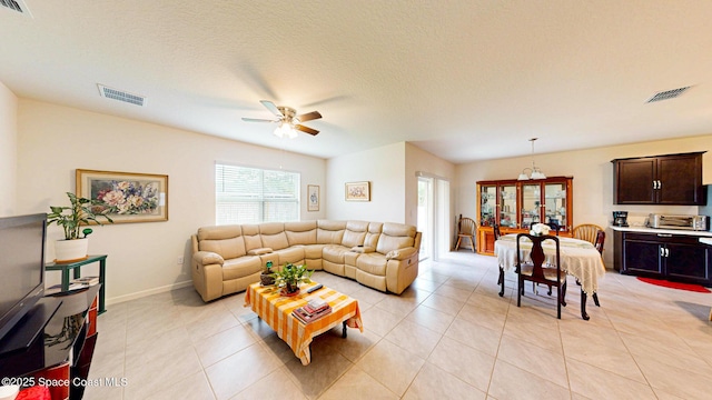 1491 Higbee St SE, Palm Bay, FL 32909 - living room with ceiling fan, light tile patterned floors, and baseboards