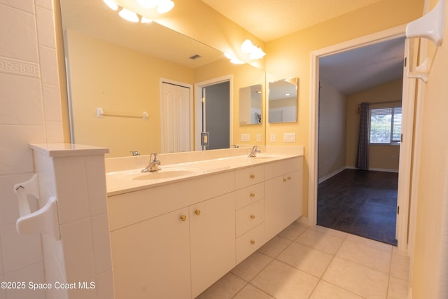 911 Indian Oaks Dr, Melbourne, FL 32901 - bathroom with tile patterned flooring, lofted ceiling, and double vanity