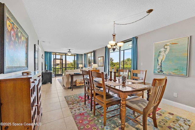300 Columbia Dr Unit 108-2, Cape Canaveral, FL 32920 - dining space with a textured ceiling, light tile patterned floors, a chandelier, a wall of windows, and ceiling fan