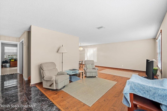 965 Bluegrass Ln, Rockledge, FL 32955 - living area featuring a textured ceiling and baseboards