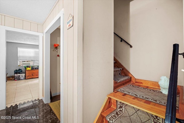 965 Bluegrass Ln, Rockledge, FL 32955 - staircase featuring a textured ceiling and cooling unit