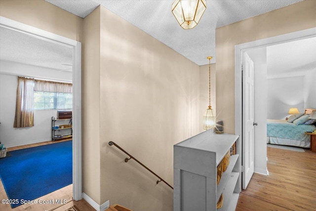 965 Bluegrass Ln, Rockledge, FL 32955 - stairs featuring a textured ceiling, wood finished floors, and baseboards