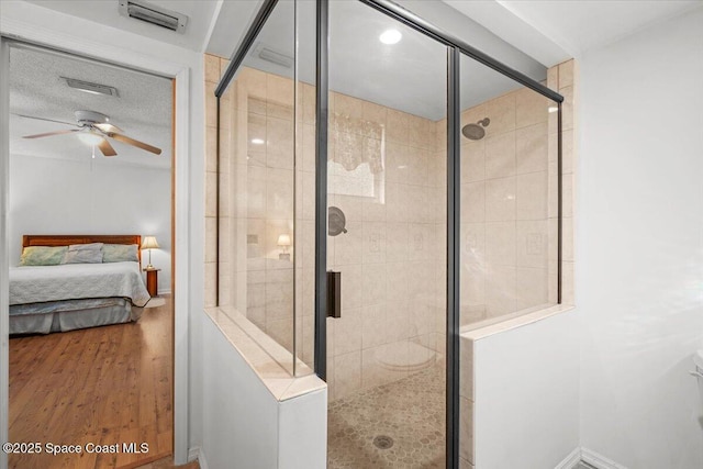 965 Bluegrass Ln, Rockledge, FL 32955 - ensuite bathroom featuring ceiling fan, a stall shower, and wood finished floors