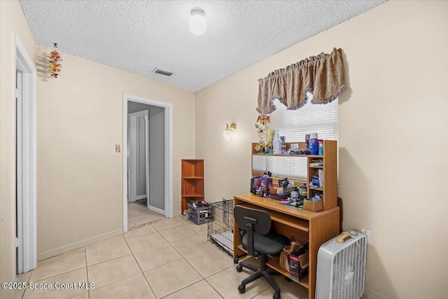 965 Bluegrass Ln, Rockledge, FL 32955 - office area with a textured ceiling, light tile patterned floors, and baseboards