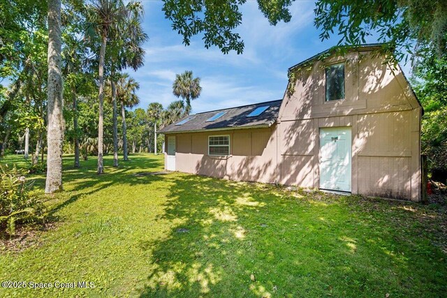 965 Bluegrass Ln, Rockledge, FL 32955 - rear view of property with a yard