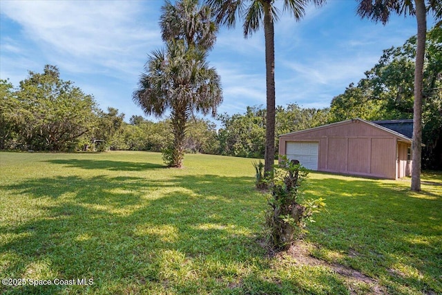 965 Bluegrass Ln, Rockledge, FL 32955 - view of grassy yard featuring an outdoor structure and a detached garage