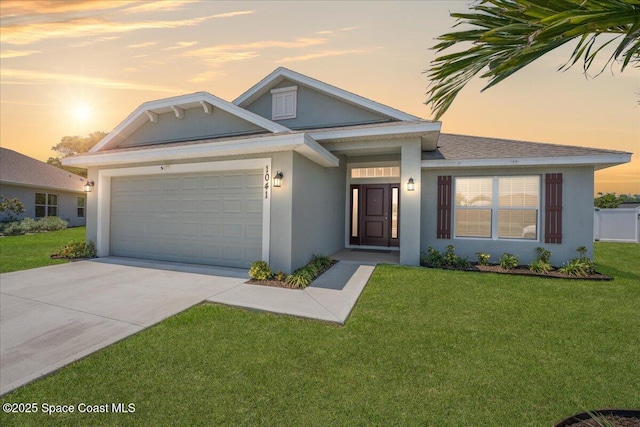 1041 Tupelo Cir, Cocoa, FL 32926 - view of front of property featuring stucco siding, an attached garage, concrete driveway, and a lawn