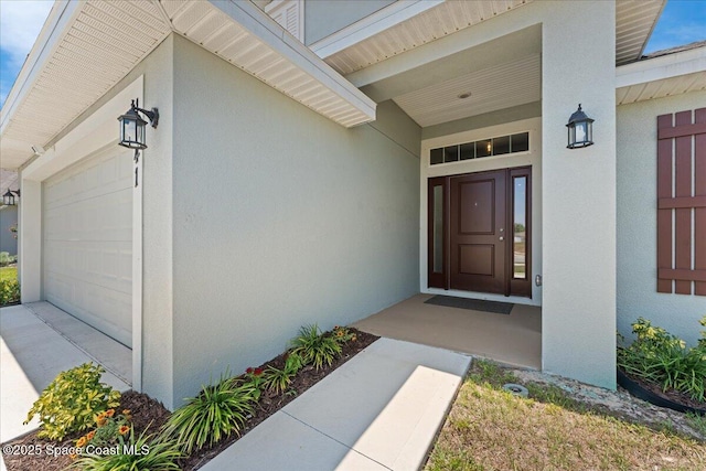 1041 Tupelo Cir, Cocoa, FL 32926 - view of exterior entry with a garage and stucco siding