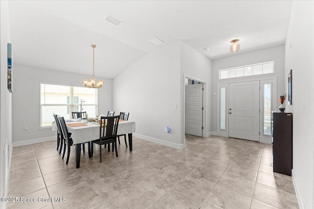 1041 Tupelo Cir, Cocoa, FL 32926 - dining room with a chandelier, baseboards, vaulted ceiling, and light tile patterned floors