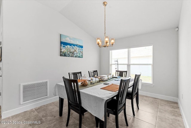 1041 Tupelo Cir, Cocoa, FL 32926 - dining area with a chandelier, vaulted ceiling, baseboards, and light tile patterned floors