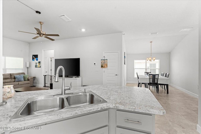 1041 Tupelo Cir, Cocoa, FL 32926 - kitchen with a sink, light countertops, a chandelier, open floor plan, and a ceiling fan