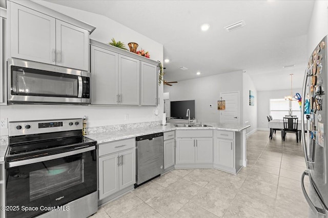 1041 Tupelo Cir, Cocoa, FL 32926 - kitchen featuring stainless steel appliances, gray cabinets, a peninsula, a sink, and ceiling fan