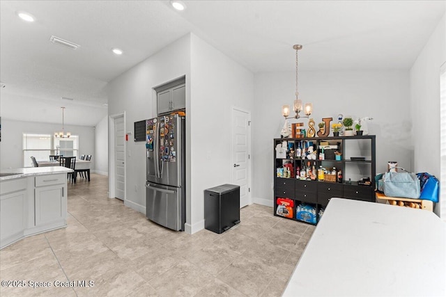1041 Tupelo Cir, Cocoa, FL 32926 - kitchen with a chandelier, stainless steel refrigerator with ice dispenser, pendant lighting, light tile patterned floors, and recessed lighting