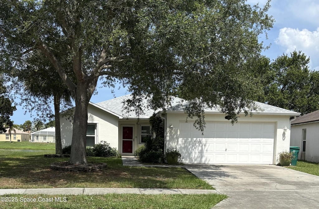 499 Benton Dr, Melbourne, FL 32901 - single story home with driveway, stucco siding, an attached garage, and a front lawn