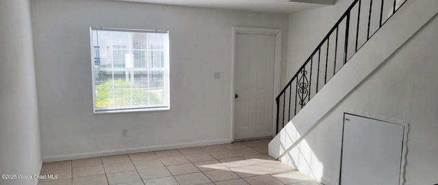 55 Needle Blvd Unit 76, Merritt Island, FL 32953 - foyer entrance featuring stairs, baseboards, and light tile patterned flooring