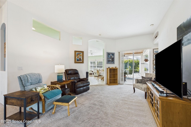 1737 Windbrook Dr SE, Palm Bay, FL 32909 - living room with carpet, a ceiling fan, and arched walkways