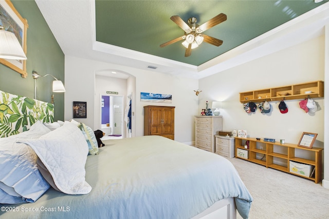 1737 Windbrook Dr SE, Palm Bay, FL 32909 - carpeted bedroom featuring a raised ceiling, arched walkways, and a ceiling fan