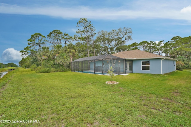 766 Tooley Rd SW, Palm Bay, FL 32908 - back of property with a lawn, a lanai, an outdoor pool, and stucco siding