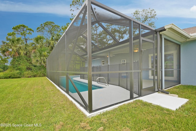 766 Tooley Rd SW, Palm Bay, FL 32908 - back of house with a patio, ceiling fan, a lawn, an outdoor pool, and stucco siding