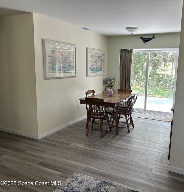 2781 Choctaw Dr, Melbourne, FL 32935 - dining room featuring baseboards and wood finished floors
