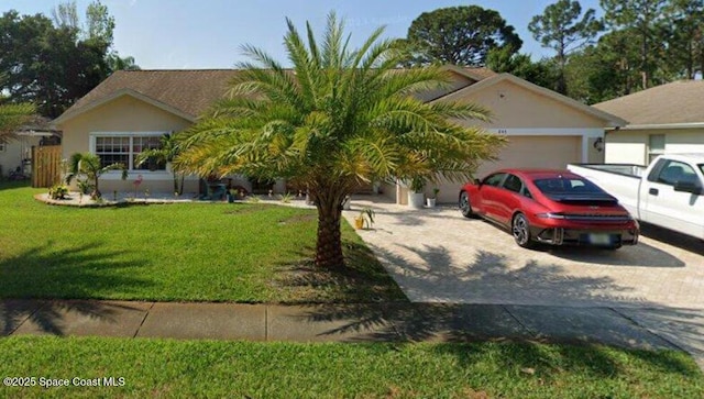 845 Hunters Creek Dr, Melbourne, FL 32904 - view of front of house featuring an attached garage, driveway, a front yard, and stucco siding