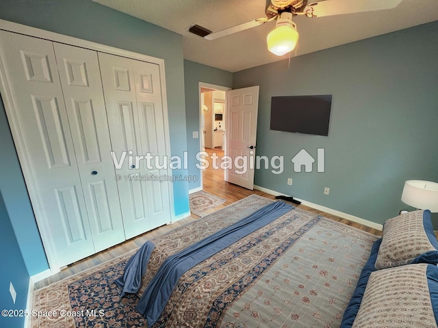 845 Hunters Creek Dr, Melbourne, FL 32904 - bedroom with baseboards, a closet, wood finished floors, and a ceiling fan