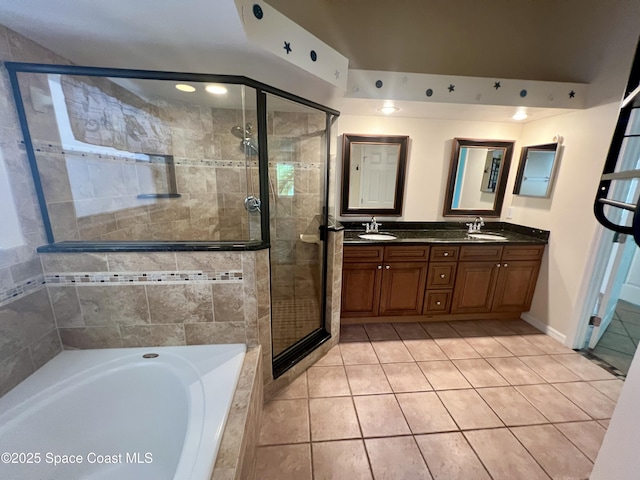 845 Hunters Creek Dr, Melbourne, FL 32904 - full bathroom featuring tile patterned flooring, a shower stall, a garden tub, and double vanity