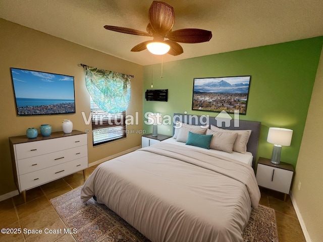 845 Hunters Creek Dr, Melbourne, FL 32904 - tiled bedroom with baseboards and ceiling fan