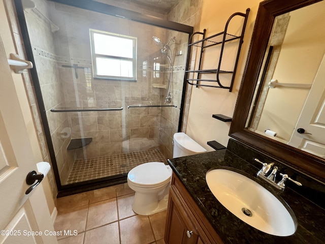 845 Hunters Creek Dr, Melbourne, FL 32904 - full bathroom featuring toilet, a shower stall, vanity, and tile patterned flooring