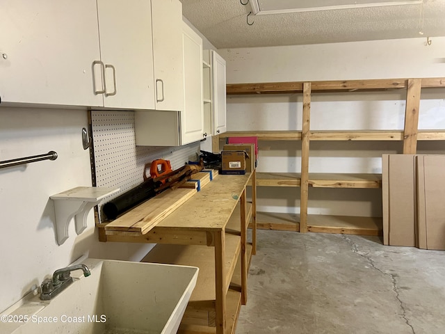 845 Hunters Creek Dr, Melbourne, FL 32904 - kitchen featuring a sink, concrete flooring, white cabinetry, and backsplash