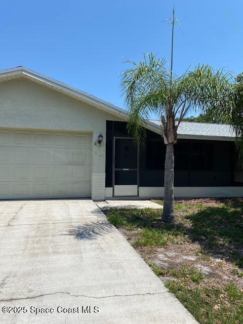 240 Perth Ave, Merritt Island, FL 32953 - ranch-style home with a sunroom, driveway, and a garage