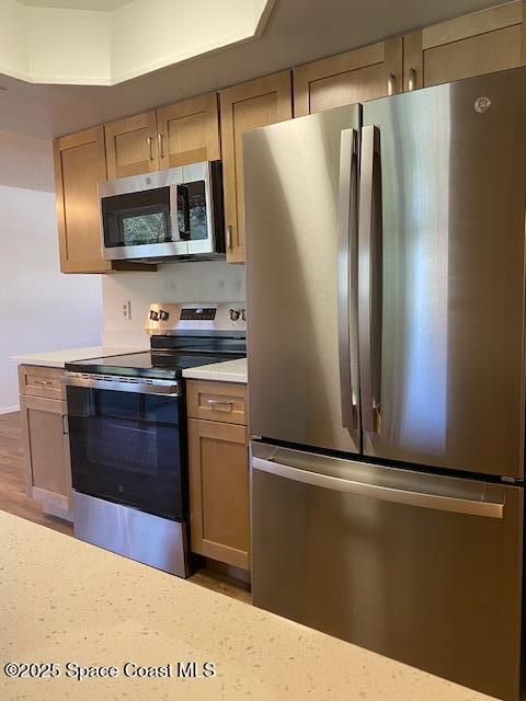 240 Perth Ave, Merritt Island, FL 32953 - kitchen with appliances with stainless steel finishes, light countertops, and wood finished floors