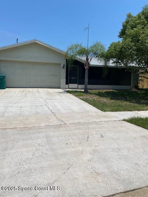 240 Perth Ave, Merritt Island, FL 32953 - view of front of property with concrete driveway and a garage
