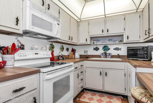 5800 N Banana River Blvd Unit 125, Cape Canaveral, FL 32920 - kitchen with white appliances, a sink, and wooden counters
