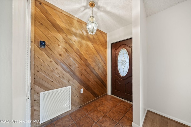 1401 Ruffin Cir SE, Palm Bay, FL 32909 - entrance foyer featuring wood walls, baseboards, and a textured ceiling
