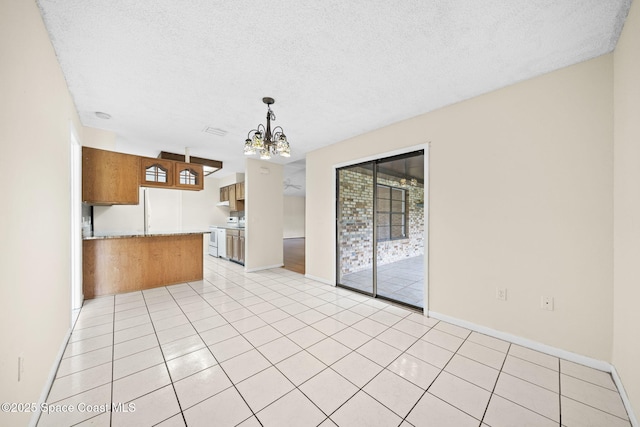 1401 Ruffin Cir SE, Palm Bay, FL 32909 - kitchen with a chandelier, healthy amount of natural light, light countertops, brown cabinetry, and a textured ceiling