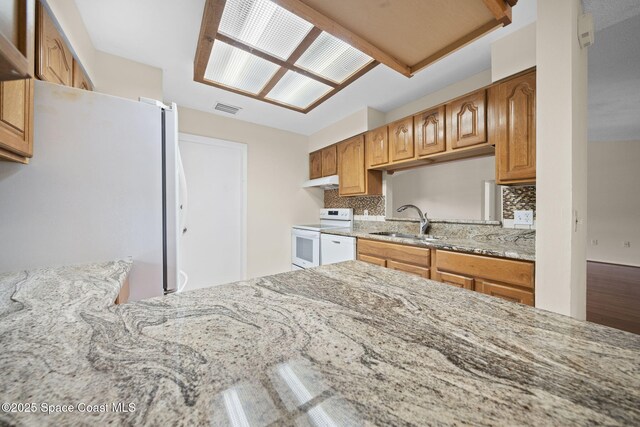 1401 Ruffin Cir SE, Palm Bay, FL 32909 - kitchen featuring white appliances, light stone countertops, and tasteful backsplash