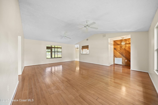 1401 Ruffin Cir SE, Palm Bay, FL 32909 - unfurnished living room featuring lofted ceiling, a ceiling fan, and wood finished floors