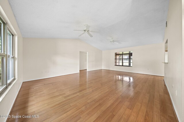 1401 Ruffin Cir SE, Palm Bay, FL 32909 - empty room with ceiling fan, lofted ceiling, light wood-style floors, and baseboards
