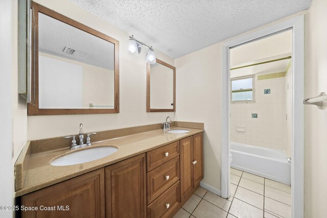 1401 Ruffin Cir SE, Palm Bay, FL 32909 - full bathroom with double vanity, tile patterned floors, toilet, a textured ceiling, and bathtub / shower combination