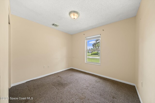 1401 Ruffin Cir SE, Palm Bay, FL 32909 - unfurnished room with carpet, a textured ceiling, and baseboards