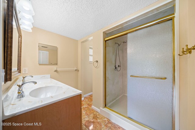 1401 Ruffin Cir SE, Palm Bay, FL 32909 - bathroom featuring a shower stall, a textured ceiling, double vanity, and tile patterned flooring