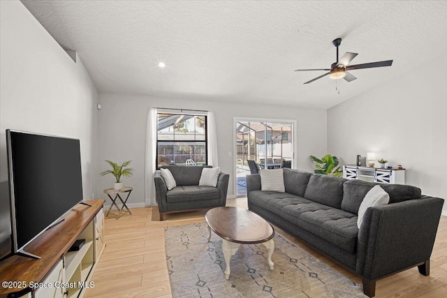 1709 Palm Ridge Rd, Melbourne, FL 32935 - living area featuring light wood-style flooring, ceiling fan, and a textured ceiling