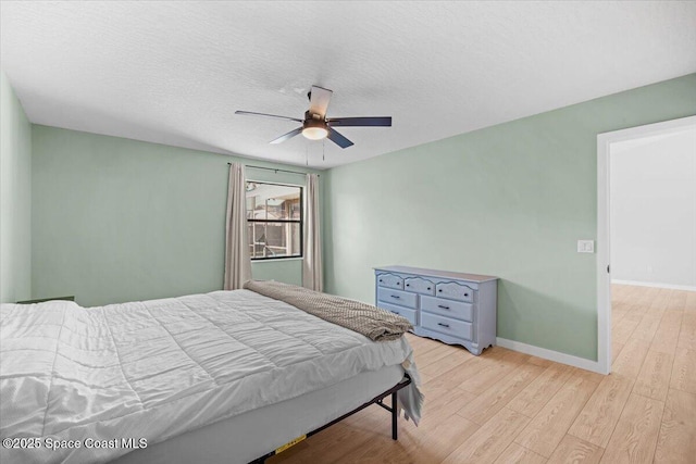 1709 Palm Ridge Rd, Melbourne, FL 32935 - bedroom featuring light wood-style floors, baseboards, and a ceiling fan
