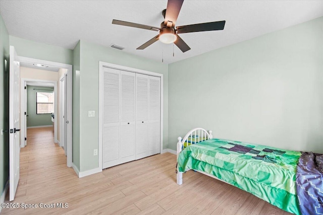 1709 Palm Ridge Rd, Melbourne, FL 32935 - bedroom featuring light wood finished floors, a closet, baseboards, and ceiling fan