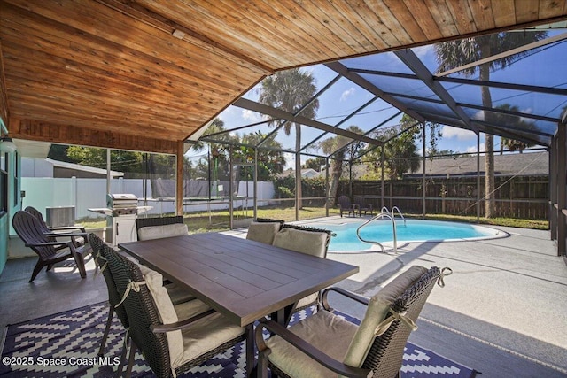 1709 Palm Ridge Rd, Melbourne, FL 32935 - view of pool featuring a patio, a fenced backyard, glass enclosure, and outdoor dining space