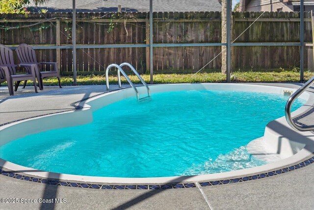 1709 Palm Ridge Rd, Melbourne, FL 32935 - view of swimming pool featuring fence and a patio
