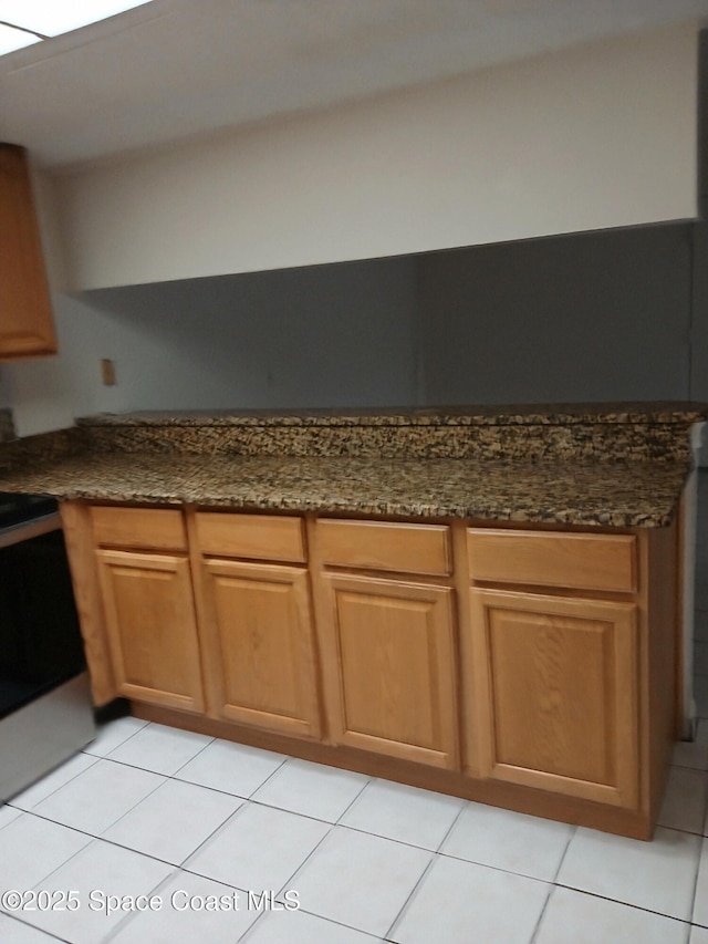 1600 Sunny Brook Ln NE Unit F106, Palm Bay, FL 32905 - kitchen featuring range, light tile patterned floors, and dark stone countertops