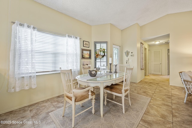 1924 Elderberry Ct NE, Palm Bay, FL 32905 - dining area featuring light tile patterned floors, vaulted ceiling, and a textured ceiling
